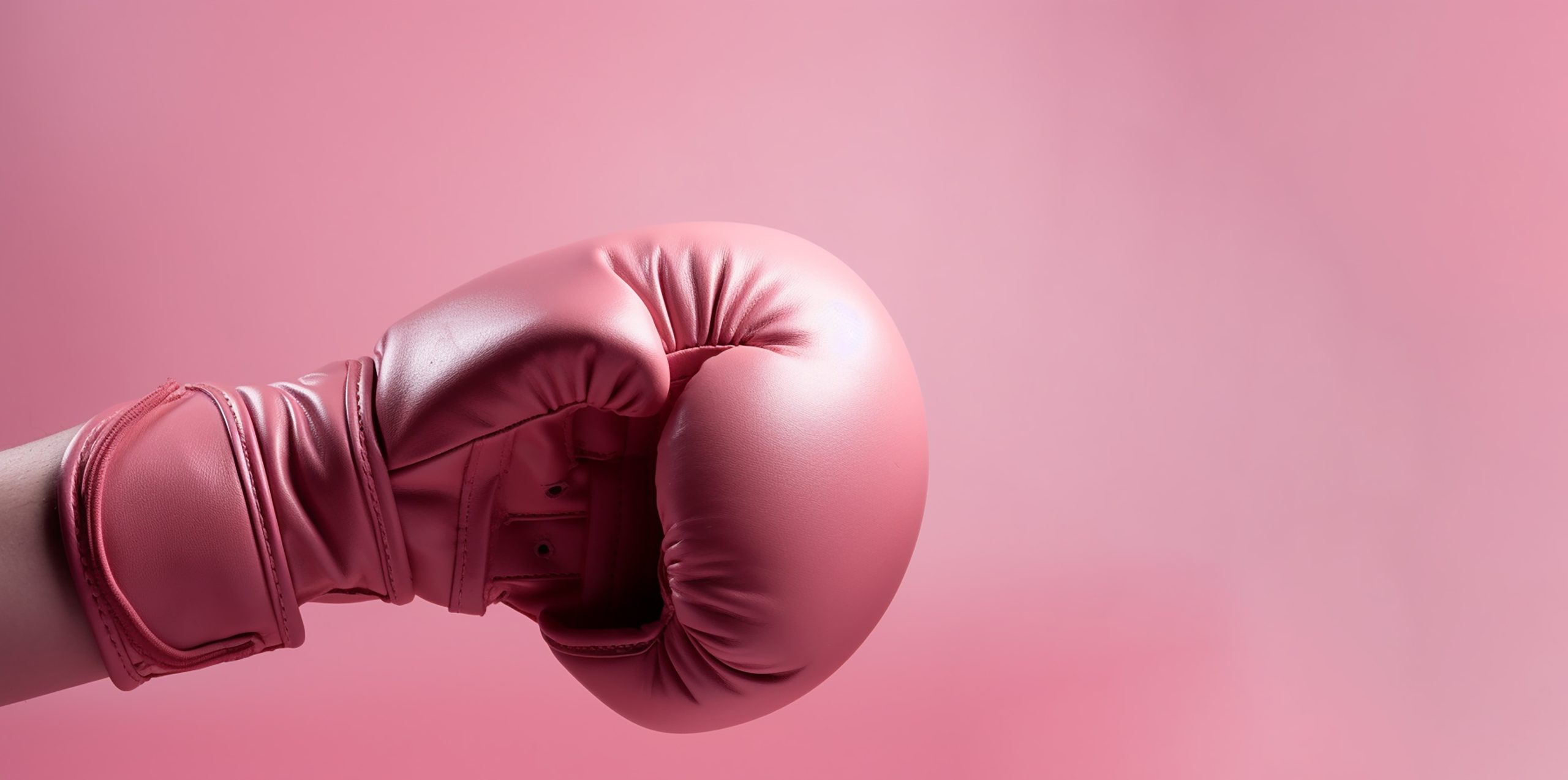 A Woman arm and hand is wearing boxing grove and is hooking or fighting with someone or against something, Breast cancer campaign, Generative AI